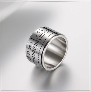 Detailed macro view of rotating stainless steel spinner ring with Arabic numerals