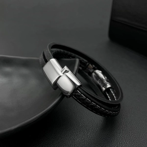 Detail of multi-layer braided leather bracelet with polished silver magnetic clasp