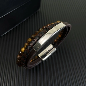 Men's multilayer leather bracelet with tiger eye stones and magnetic clasp on dark background