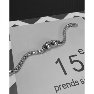 Hip-hop silver titanium steel chain bracelet featuring double skull head ornaments