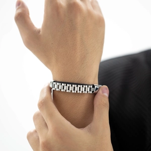 Men's silver stainless steel watchband link bracelet on wrist with a minimalist design