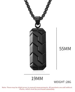 Detail view of black rectangular pendant with geometric tire texture and box chain