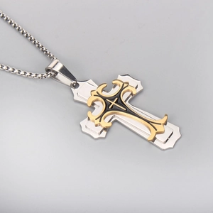 Close-up of a layered cross pendant with black enamel details and silver box chain