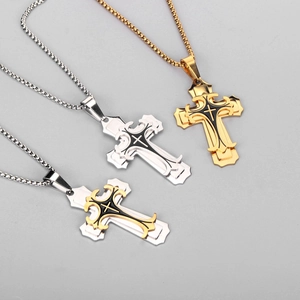 Macro view of triple gothic layered cross pendants with black enamel and bead chain