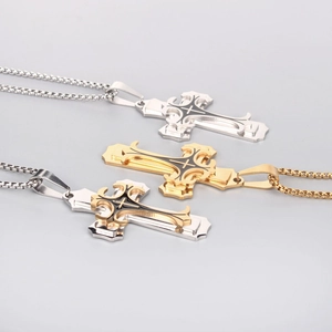 Detailed close-up of retro gothic cross pendants in gold and silver with black enamel
