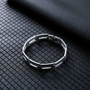 Macro detail of silver stainless steel chain bracelet with rectangular link design