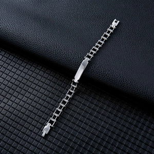 Close-up of industrial style stainless steel bike chain bracelet with a polished ID tag