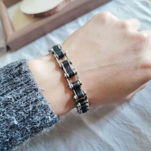 Close-up of a men's punk bike chain bracelet with silver stainless steel and black silicone