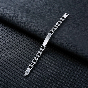 Detail of stainless steel biker chain bracelet with polished ID bar and secure fold-over clasp