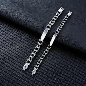 Polished stainless steel motorcycle curb chain bracelets with ID plates on leather surface