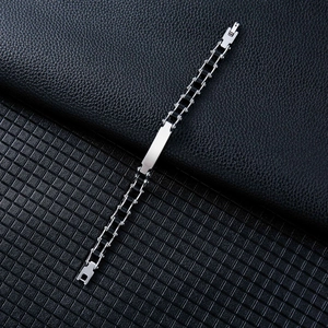 Detail of bicolored stainless steel bracelet featuring a polished engravable curved plate