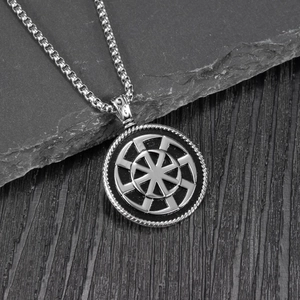 Vintage Viking Kolovrat sun wheel pendant necklace with silver box chain on dark rock