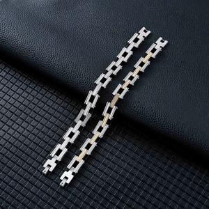 Detailed macro view of men's stainless steel multi-layered link chain bracelet with fold-over clasp
