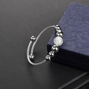 Silver stainless steel cable bangle with zircon paved ball and smooth bead accents