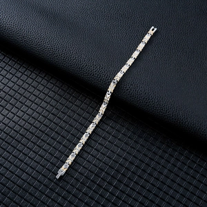 Detail of magnetic butterfly steel bracelet with silver and gold textured links
