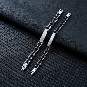 Close-up of dual stainless steel motor chain bracelets with sleek metal plate details