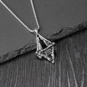 Retro stainless steel Horus Eye triangle pendant necklace with wings on dark stone background