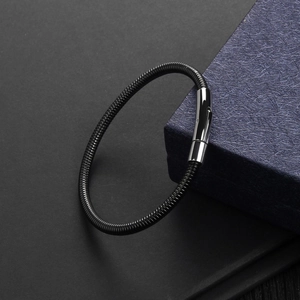 Detail of black snake chain bracelet with polished silver clasp on jewelry box