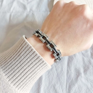 Industrial silver and black stainless steel layered bracelet for men worn on wrist