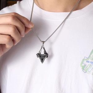 Retro stainless steel Horus Eye triangle pendant on box chain worn by male model