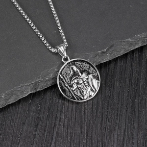 Macro view of vintage Spartan warrior pendant on black slate with pearl chain detail
