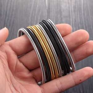 Three-color spring coil bracelets in gold, silver and black stainless steel for women