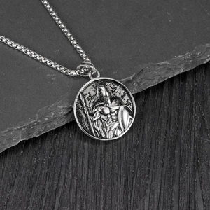 Close-up of vintage silver Spartan warrior relief pendant on a steel bead chain
