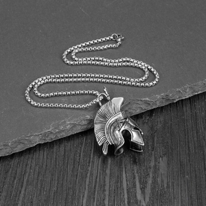 Detail of vintage spartan helmet pendant with rugged matte silver finish on a metal chain