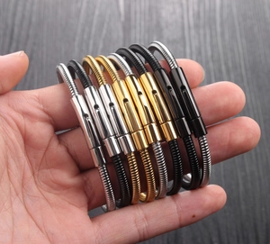 Detailed view of flexible snake chain bracelets in silver, gold, and black steel