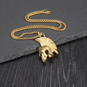 Detailed view of a golden Spartan helmet pendant with vintage textures on a round box chain
