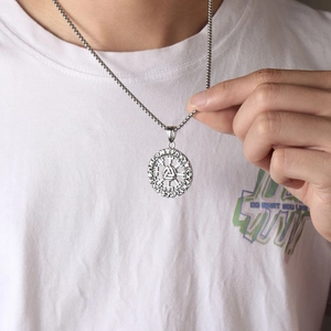 Nordic Viking rune compass pendant necklace in vintage stainless steel on a model