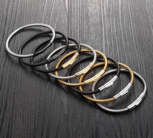 Detail of woven stainless steel bracelets in gold silver and black with magnetic clasps