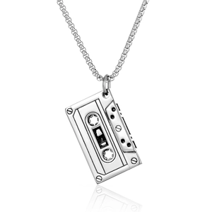 Macro detail of retro cassette tape pendant with polished silver finish and link chain