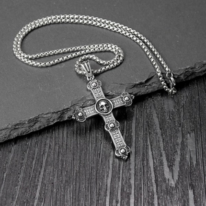 Macro detail of gothic skull cross pendant with vintage oxidized finish and box chain