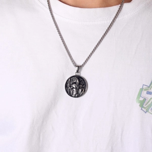 Vintage Spartan warrior coin pendant necklace shown on person wearing a white T-shirt
