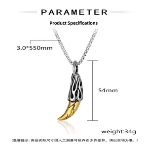 Macro detail of punk wolf tooth pendant with silver flame carvings and golden cracked texture