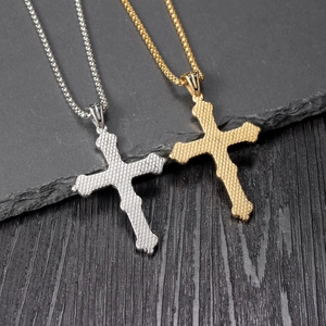 Polished gold and silver textured Celtic cross necklaces with box chains on stone