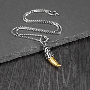 Retro wolf tooth pendant necklace in silver and gold steel for a punk aesthetic look
