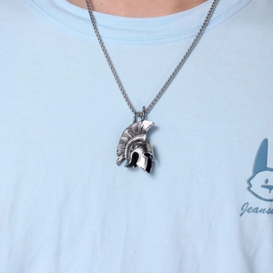 Macro view of vintage Spartan helmet pendant with industrial blacked finish and pearl chain