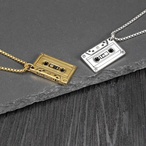 Detailed close-up of retro cassette tape pendants in gold and silver finishes with box chain