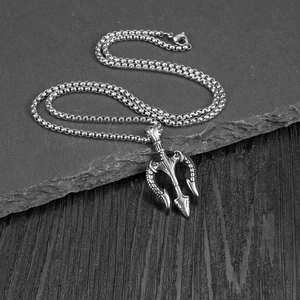 Retro stainless steel trident pendant necklace for men on a dark slate background