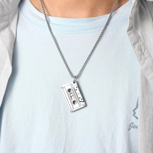 Retro silver cassette tape pendant necklace with a metal box chain worn on a model