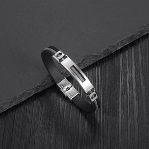 Close-up of industrial black silicone bracelet featuring a stainless steel metal clasp