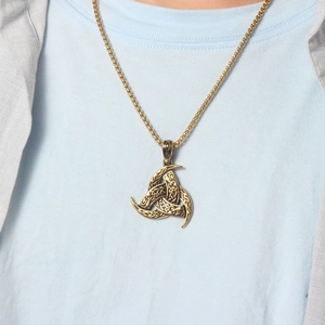 Detail of Viking Triple Horn of Odin pendant necklace with Celtic knot patterns on a model