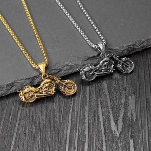 Detail of creative punk motorcycle pendants in gold and silver with vintage finish
