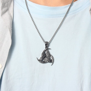Detail of Viking Horn of Odin pendant necklace with Celtic Knot on a casual outfit