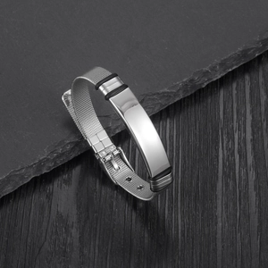 Detail of adjustable silver mesh bracelet with smooth central plaque and black rubber rings