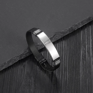 Close-up of black mesh strap bracelet featuring a polished silver metal plate and adjustable buckle