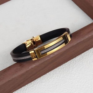 Detail of stainless steel stamp on black silicone bracelet with gold and silver mesh inlay
