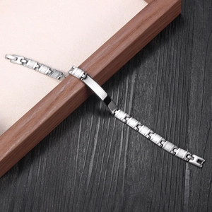 Silver stainless steel chain bracelet with a blank ID plate shown on a wooden background
